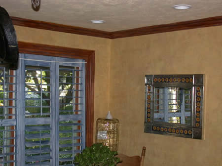 Plaster wall finish, distressed shutters and moulding.  Northport, NY.